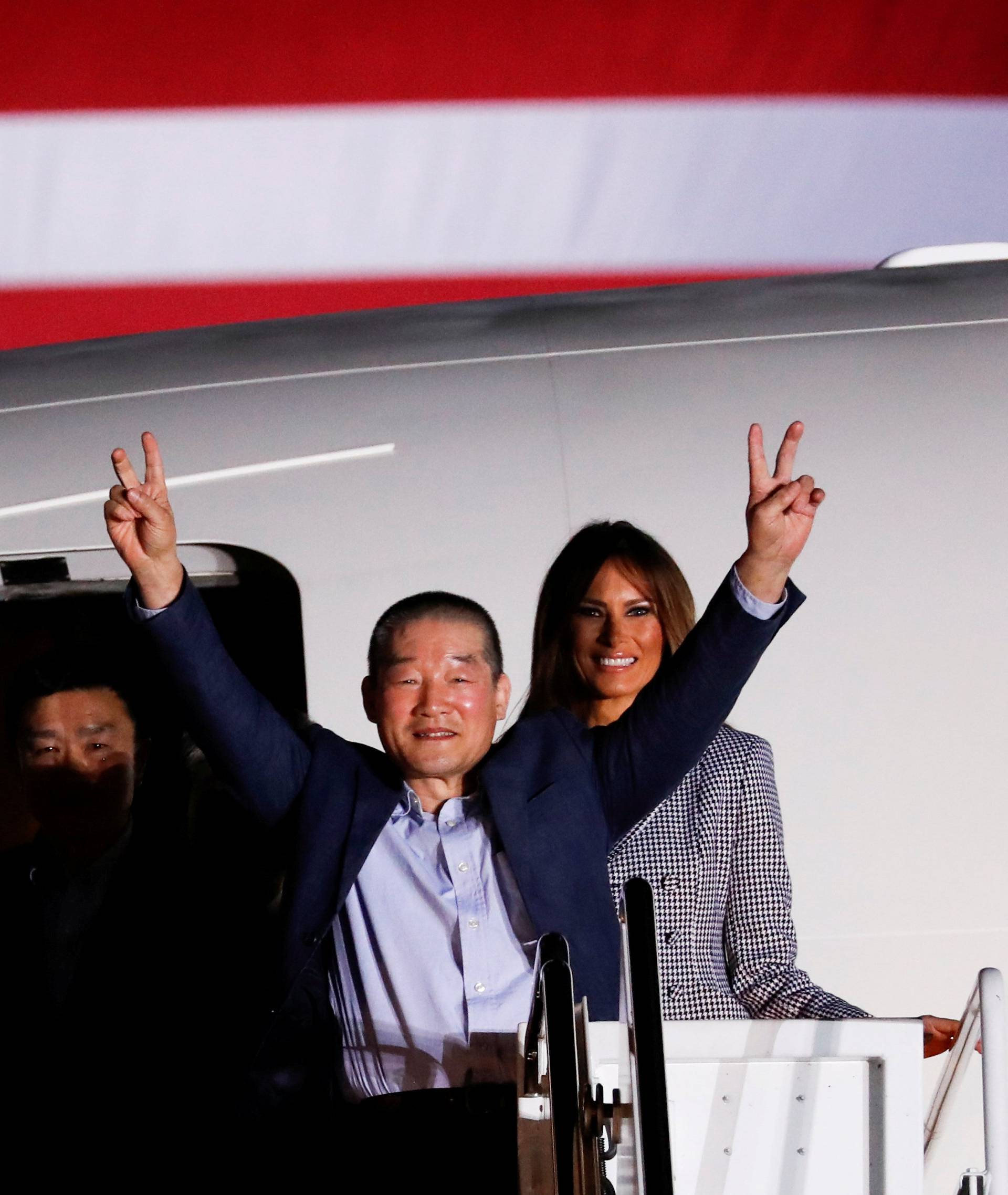 One of the Americans formerly held hostage in North Korea gestures next to U.S.President Donald Trump and first lady Melania Trump, upon their arrival at Joint Base Andrews