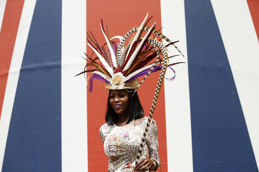 Britain Horse Racing Ladies Day Racegoer wears hat