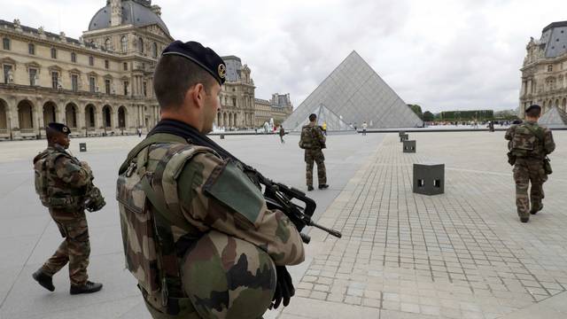 FILE PHOTO - French army soldiers patrol near the Louvre Museum Pyramid's main entrance in Paris