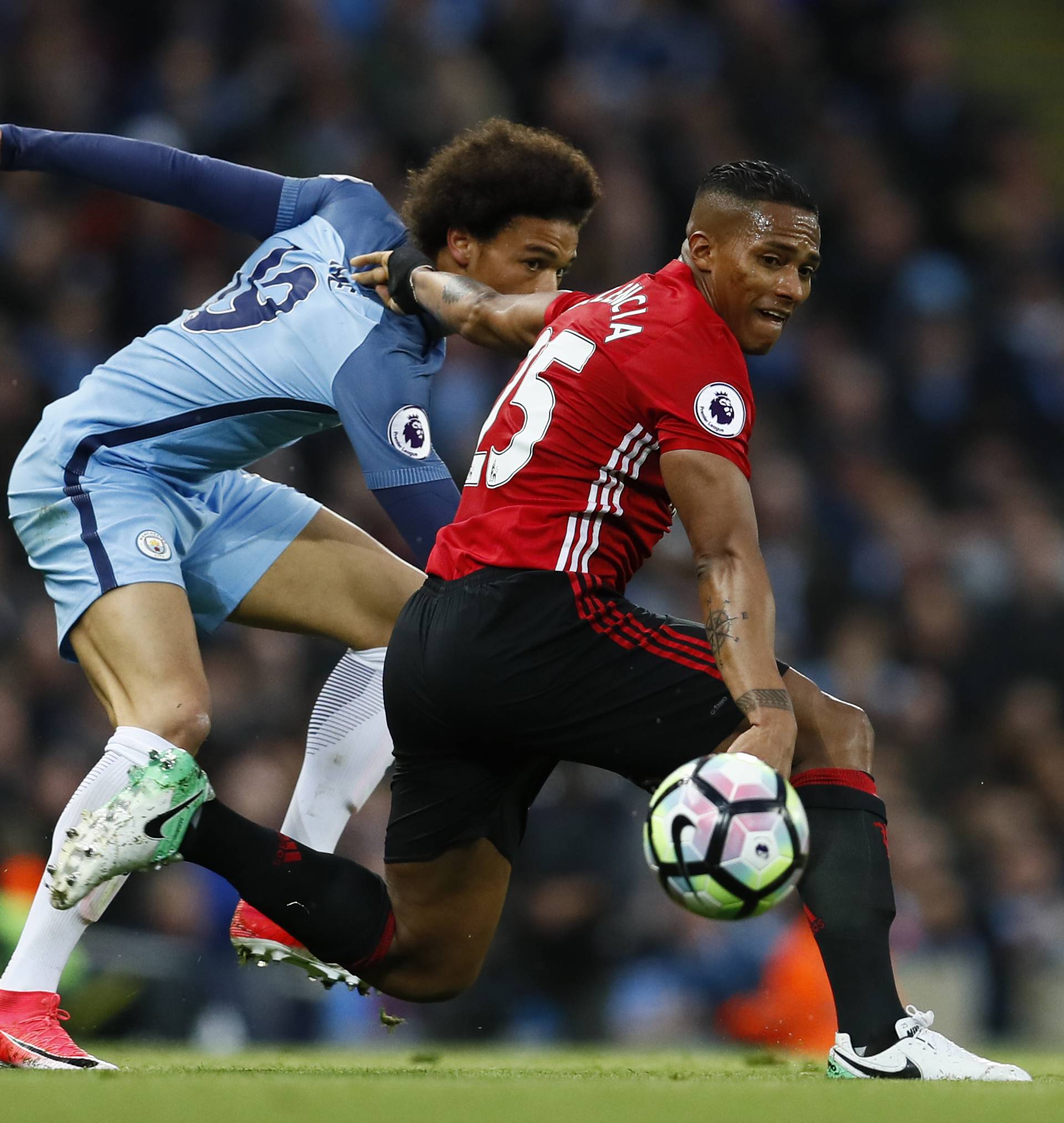 Manchester City's Leroy Sane in action with Manchester United's Antonio Valencia