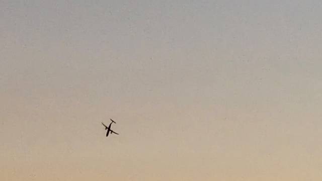 A Horizon Air Bombardier Dash 8 Q400, reported to be hijacked, flies over University Place in this still image taken from a video obtained from social media