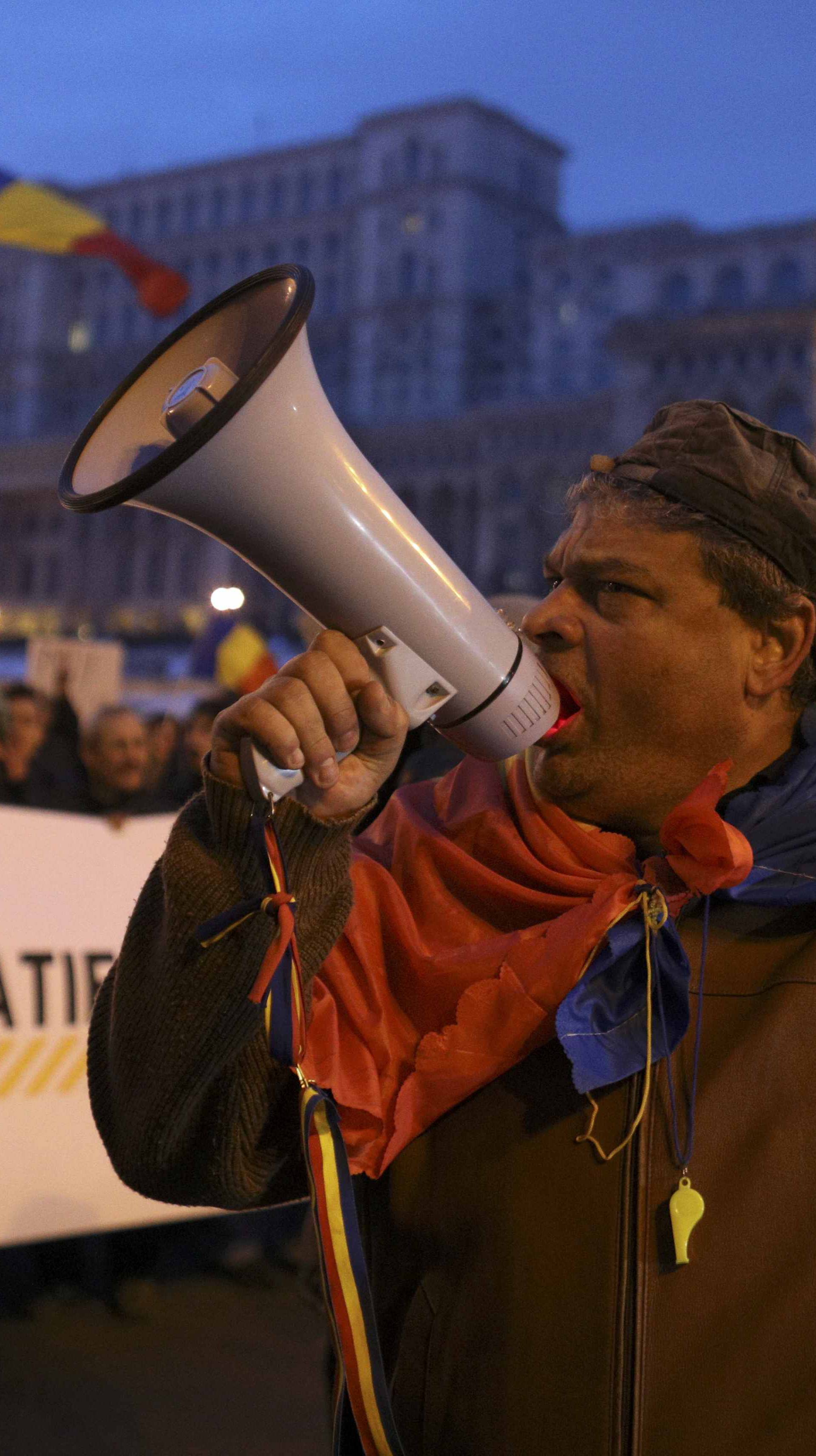 Man shouts slogans during demonstration against cabinet decree passed earlier in week decriminalising some graft offences, in Bucharest