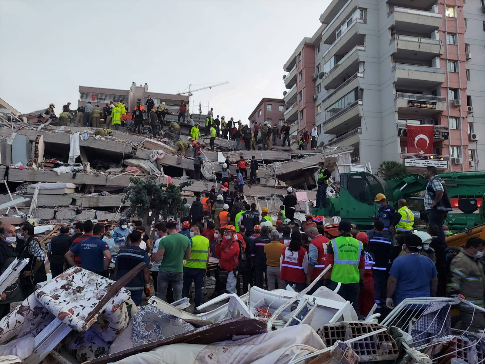 People search for survivors at a collapsed building after a strong earthquake struck the Aegean Sea where some buildings collapsed in the coastal province of Izmir