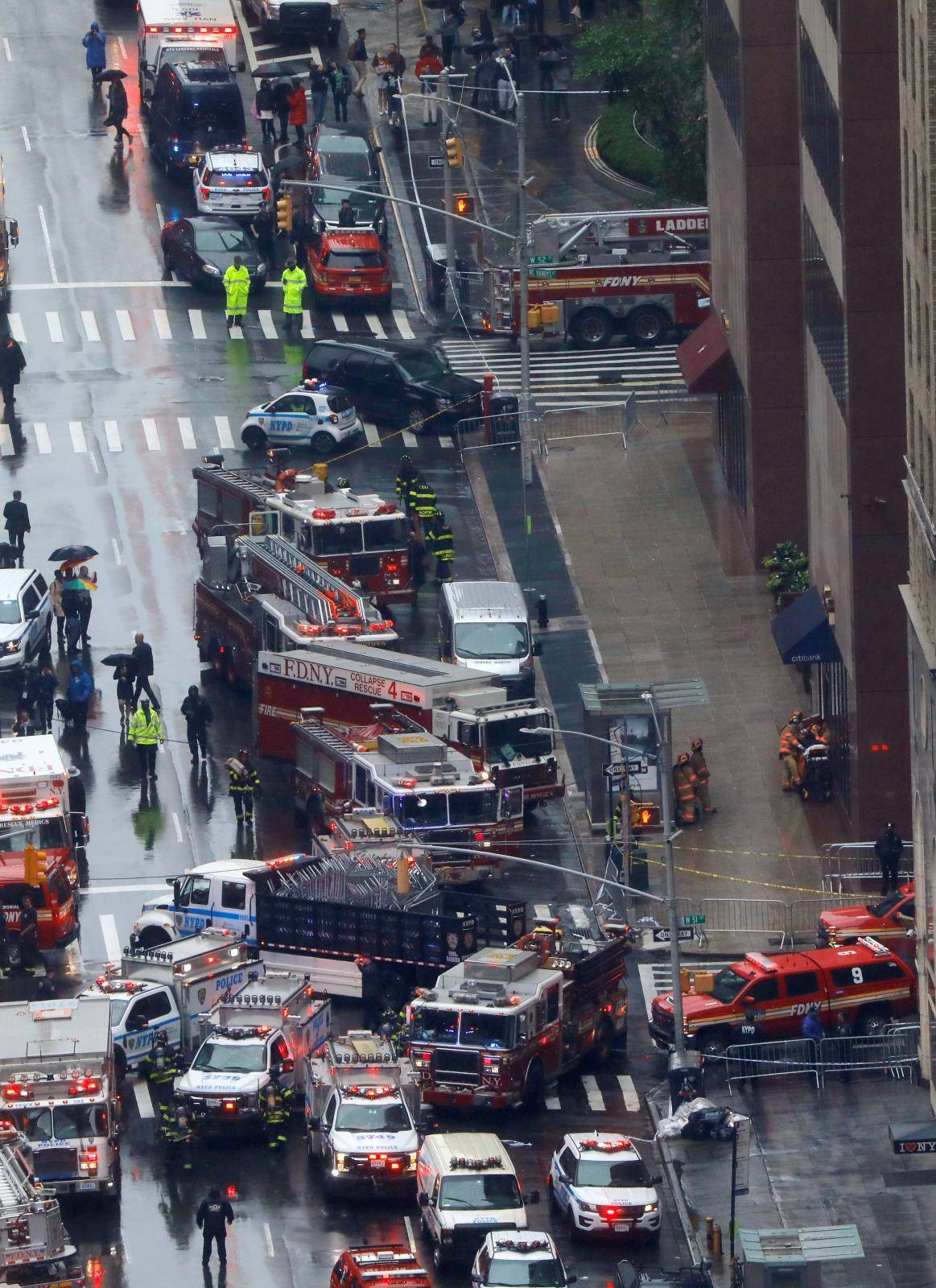 Emergency vehicles are seen outside 787 7th Avenue in midtown Manhattan where a helicopter crashed in New York