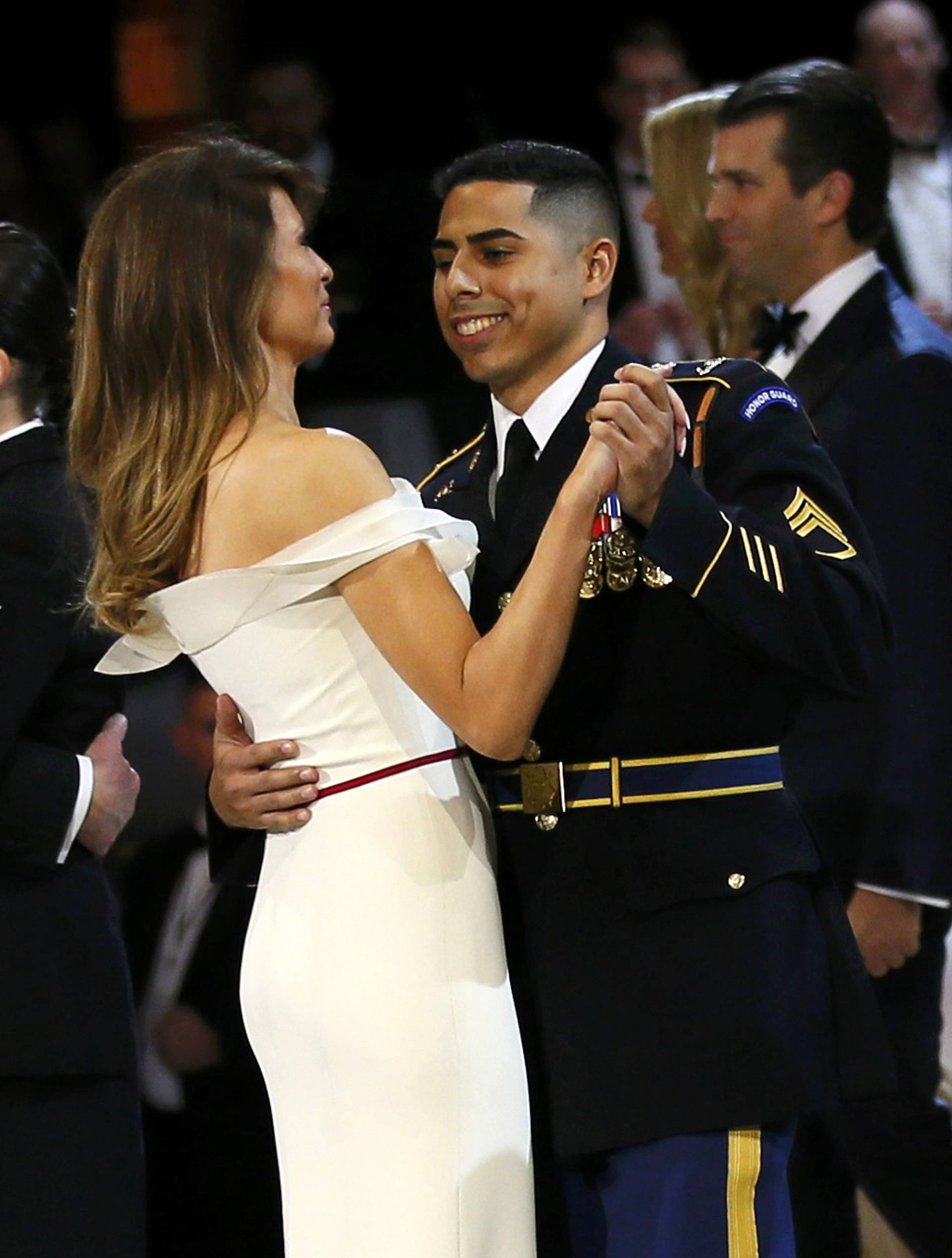 U.S. Army Staff Sergeant Medina dances with U.S. first Lady Trump as U.S. Navy Petty Officer Second Class Cartmell dances with President Trump during the "Salute to Our Armed Services Ball" in Washington