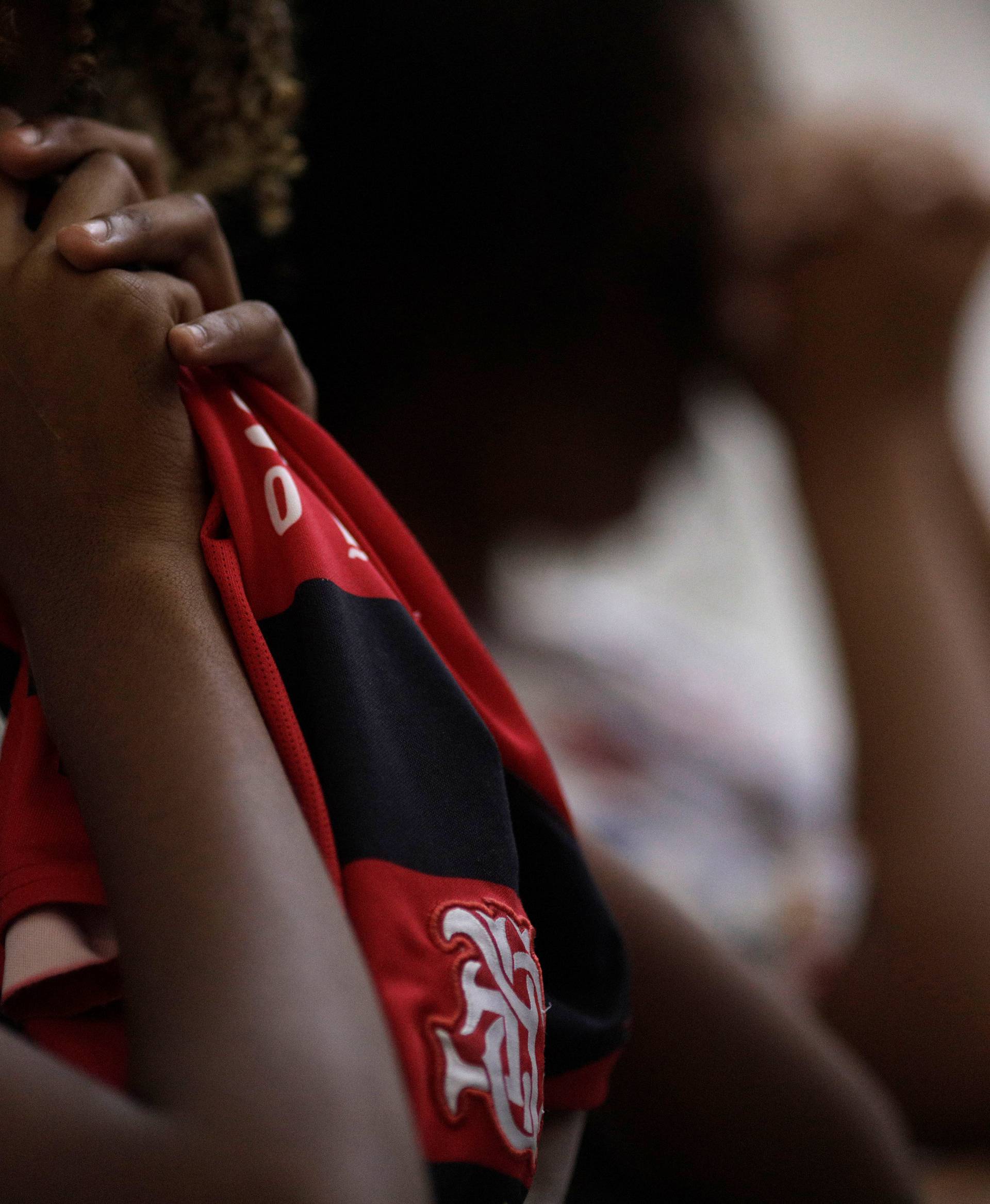 A supporter of Flamengo reacts during a mass in memory of the victims of the club's training center deadly fire in Rio de Janeiro