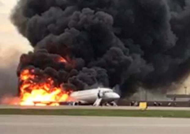 A passenger plane is seen on fire after an emergency landing at the Sheremetyevo Airport outside Moscow