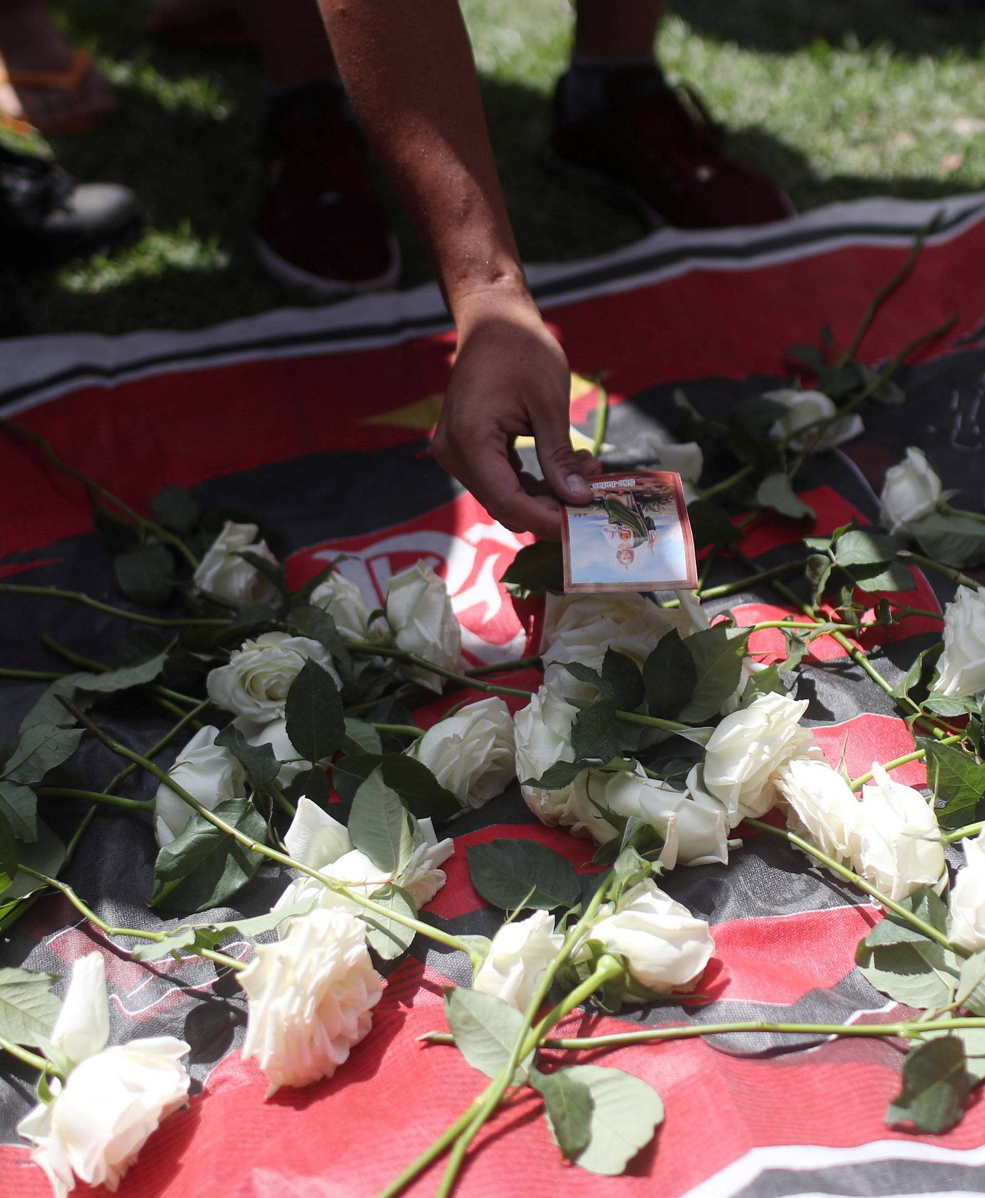 Fans of Brazilian football club Flamengo lay flowers at the club's entrance, after a deadly fire, in Rio de Janeiro