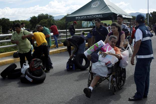 People cross to Venezuela over the Simon Bolivar international bridge after shopping in Cucuta