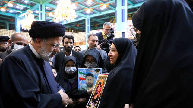 Iranian President Ebrahim Raisi meets with the families of security forces killed during Iran's protests, in Tehran