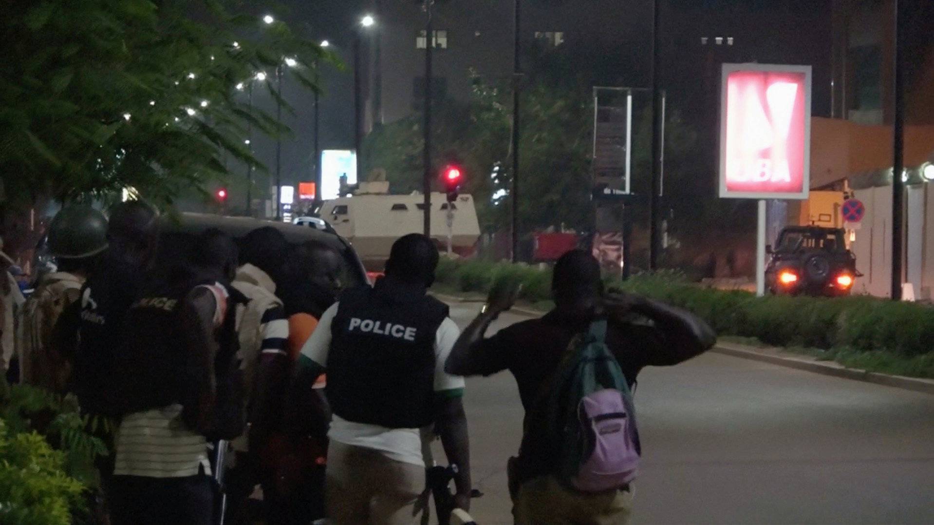 Police are seen on a street following an attack by gunmen on a restaurant in Ouagadougou, Burkina Faso, in this still frame taken from video
