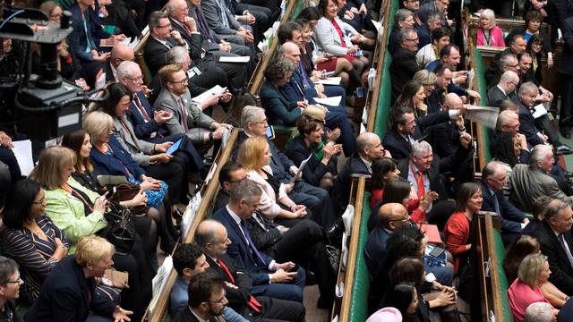 MPs react in Parliament following the vote on Brexit in London