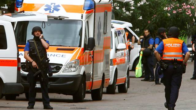 Swiss police officers stand on a crime site in Schaffhausen