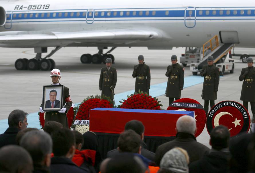 Flag-wrapped coffin of late Russian Ambassador to Turkey Karlov is carried to a plane during a ceremony at Esenboga airport in Ankara