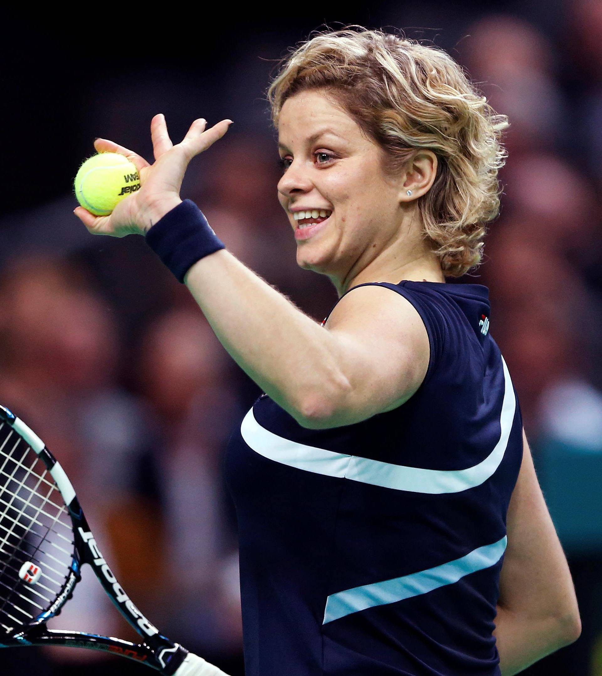 FILE PHOTO: Belgium's Clijsters waves to supporters during an exhibition tennis match to mark her retirement