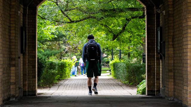 FILE PHOTO: Students walk on the grounds of the University of Toronto in Toronto