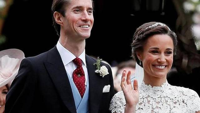 FILE PHOTO: Pippa Middleton and James Matthews pose for photographs after their wedding at St Mark's Church in Englefield