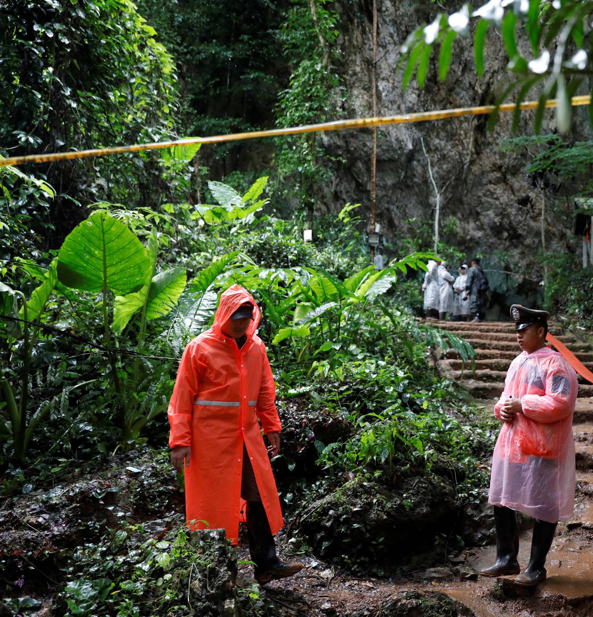 Rescue workers are seen near Tham Luang cave complex during a search for members of an under-16 soccer team and their coach, in the northern province of Chiang Rai