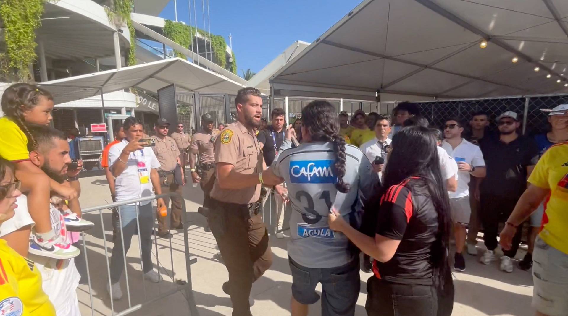 People get into a scuffle with the police at Hard Rock Stadium, in Miami