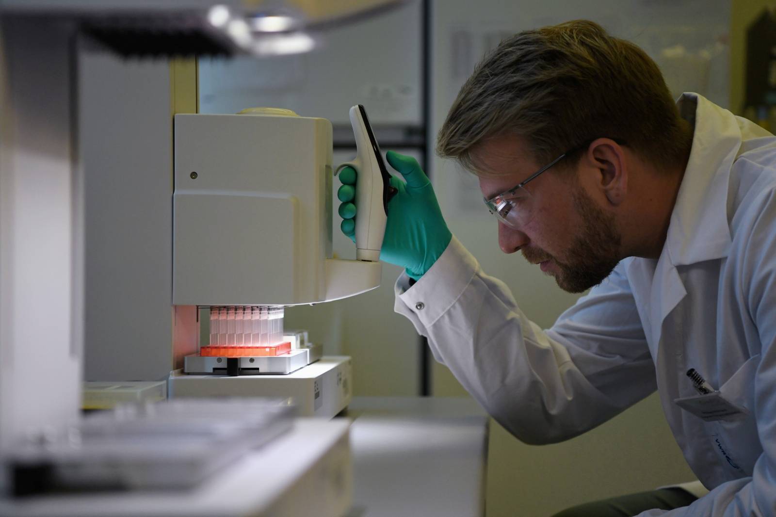 Employee Philipp Hoffmann, of German biopharmaceutical company CureVac, demonstrates research workflow on a vaccine for the coronavirus (COVID-19) disease at a laboratory in Tuebingen