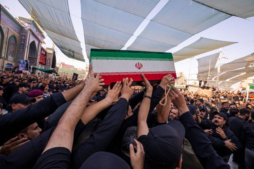 Mourners carry the coffins of family members of Iran’s late Supreme Leader Ayatollah Ali Khamenei, inside the shrine of Imam Abbas during funeral ceremonies in Karbala