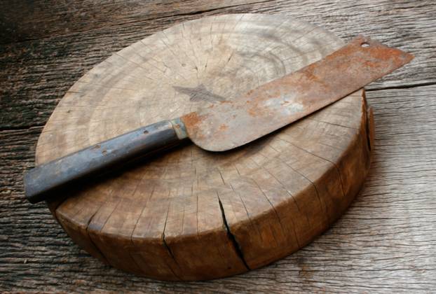 wood cutting board and rusty knife