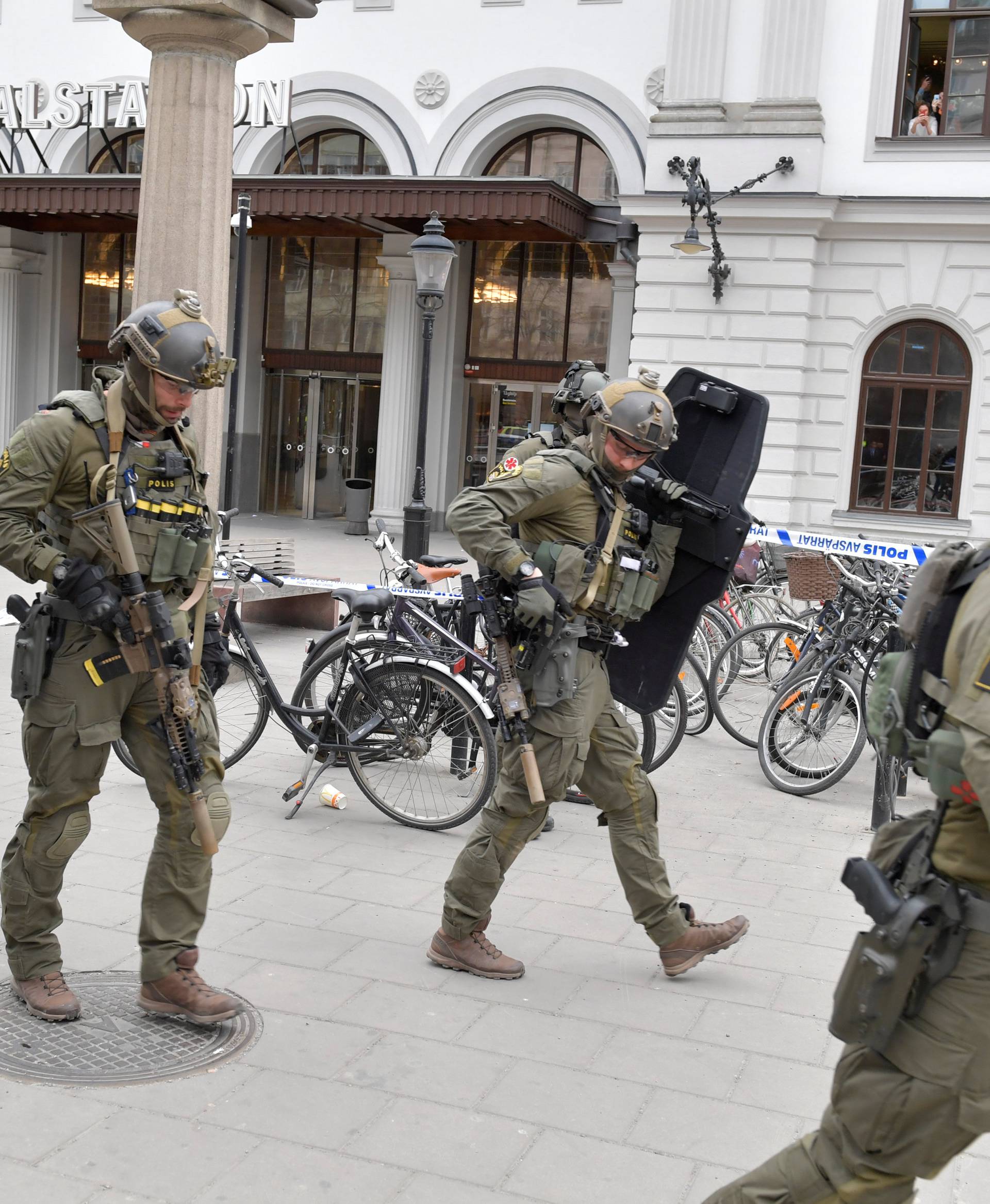 Police officers are seen outside Stockholm Central station after people were killed when a truck crashed into department store Ahlens, in central Stockholm