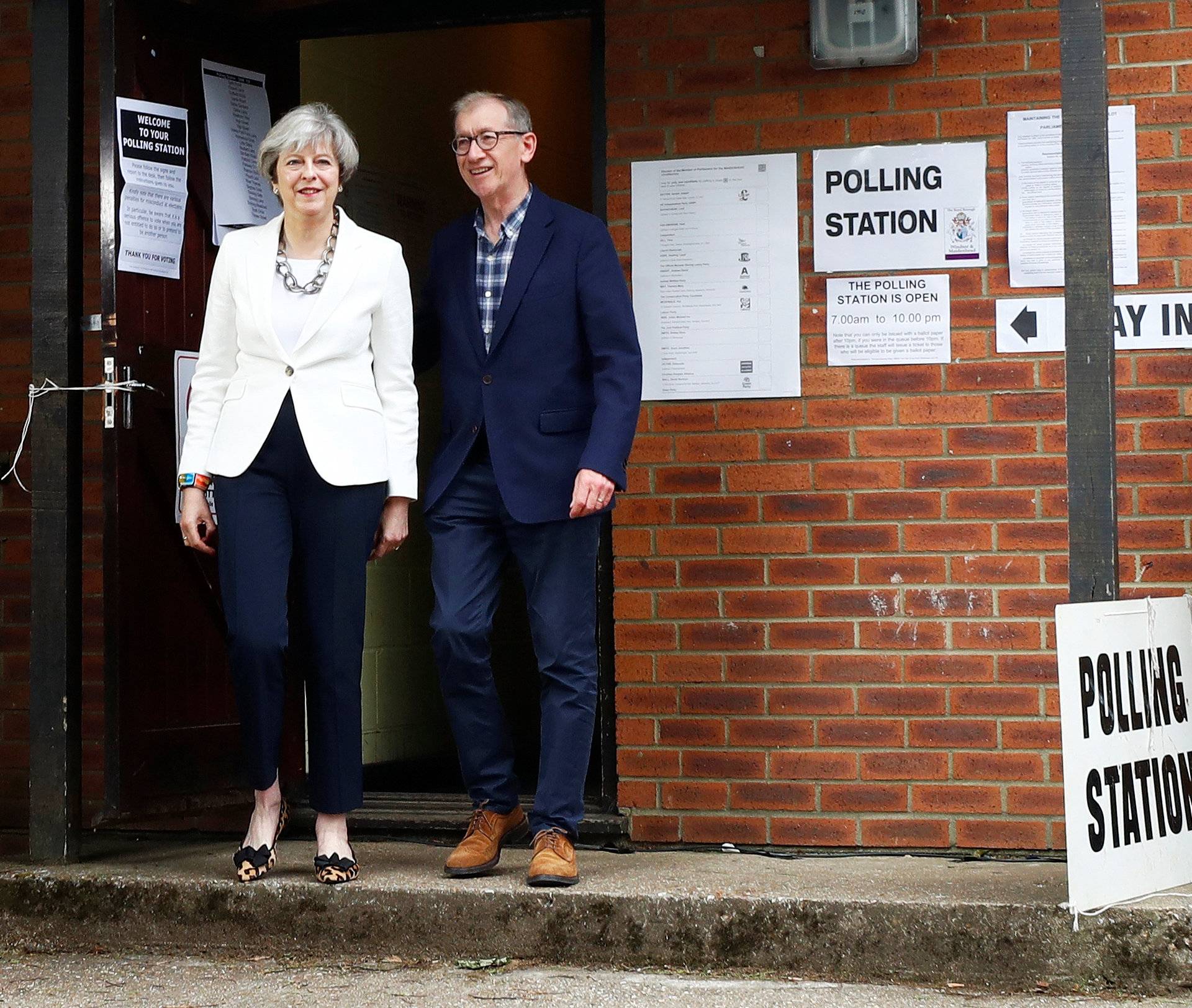 Britain's Primer Minister Theresa May and her husband Philip leave a polling station in Sonning