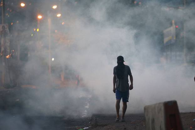A supporter of presidential candidate Salvador Nasralla walks on a street during a protest caused by the delayed vote count for the presidential election at Villanueva neighborhood in Tegucigalpa
