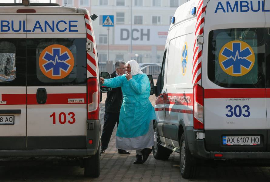 A medic smokes near ambulances in Kharkiv