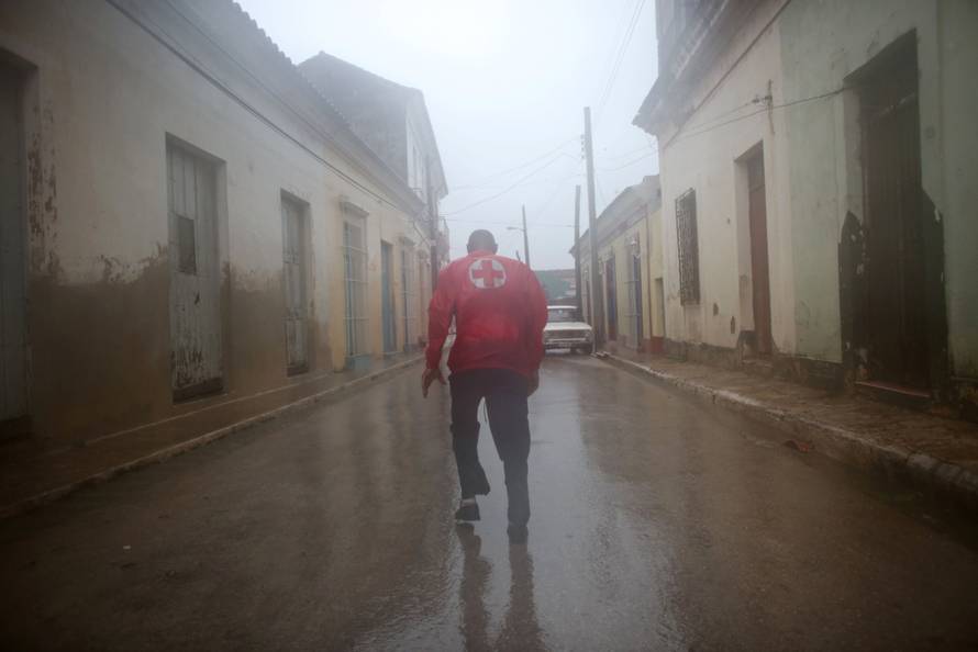 A member of the civil defense runs on the street as Hurricane Irma passes by Remedios