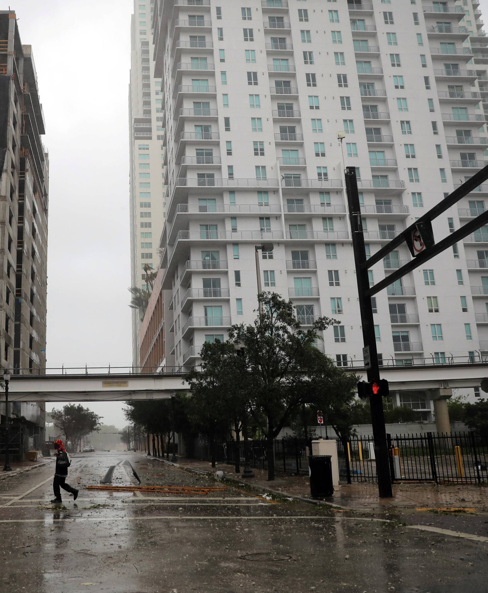 A man walks along an empty street as Hurricane Irma arrives at south Florida, in downtown Miami, Florida, U.S.