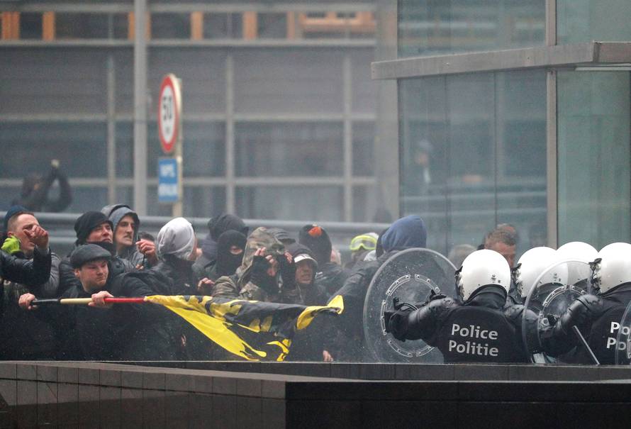 Police officers face off with far-right supporters during a protest against Marrakesh Migration Pact, outside European Commission headquarters, in Brussels