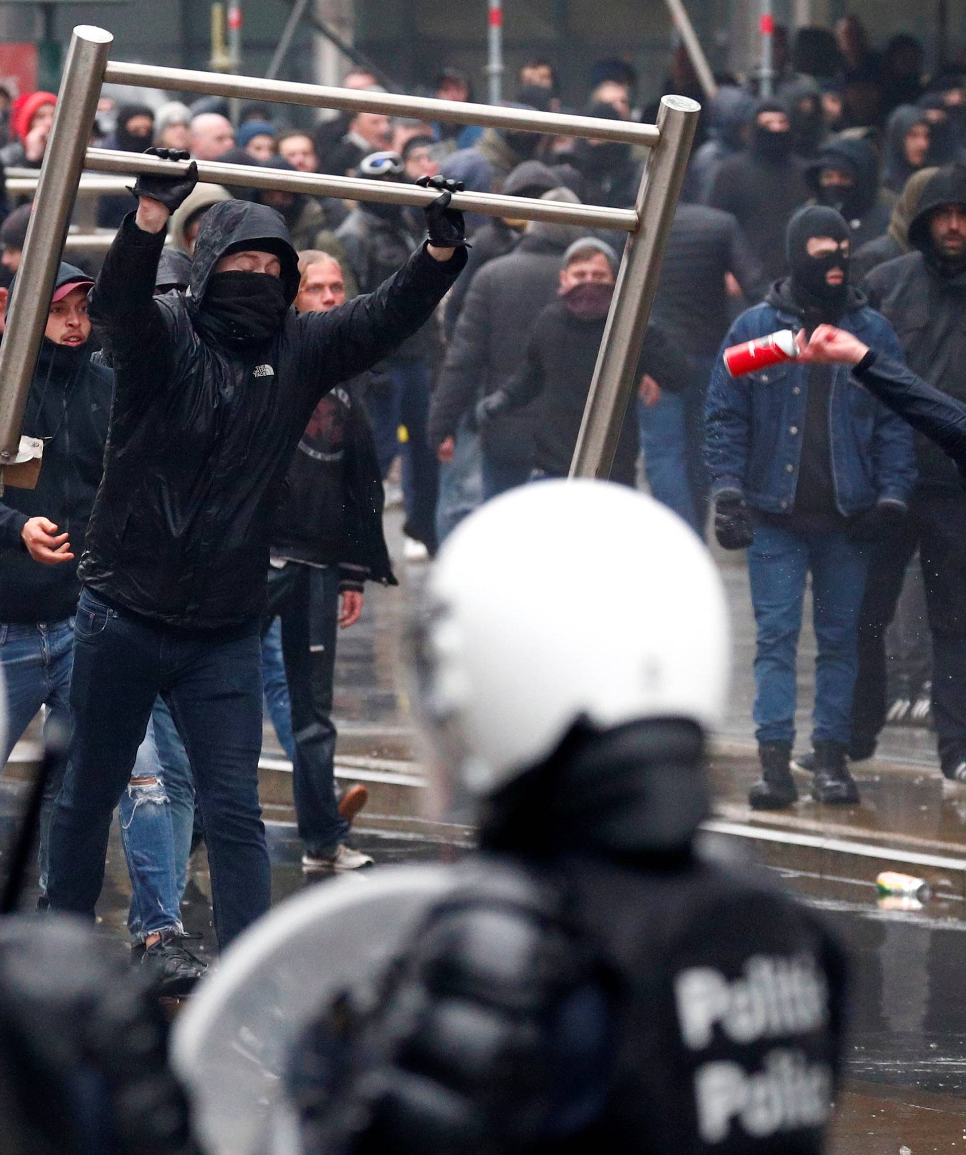 Far-right supporters throw barricades during a protest against Marrakesh Migration Pact in Brussels