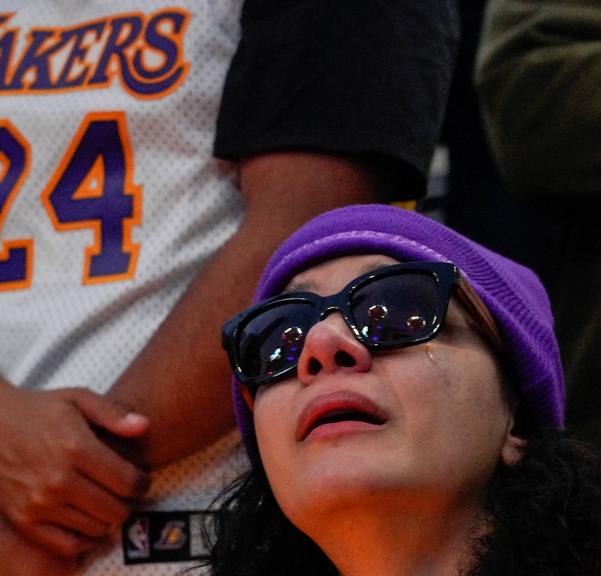 A mourner reacts while gathering with others in Microsoft Square near the Staples Center to pay respects to Kobe Bryant after a helicopter crash killed the retired basketball star, in Los Angeles