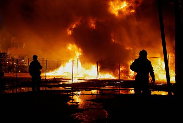 Rescuers work at the site of a Russian missile strike, amid Russia's attack on Ukraine, in Kyiv