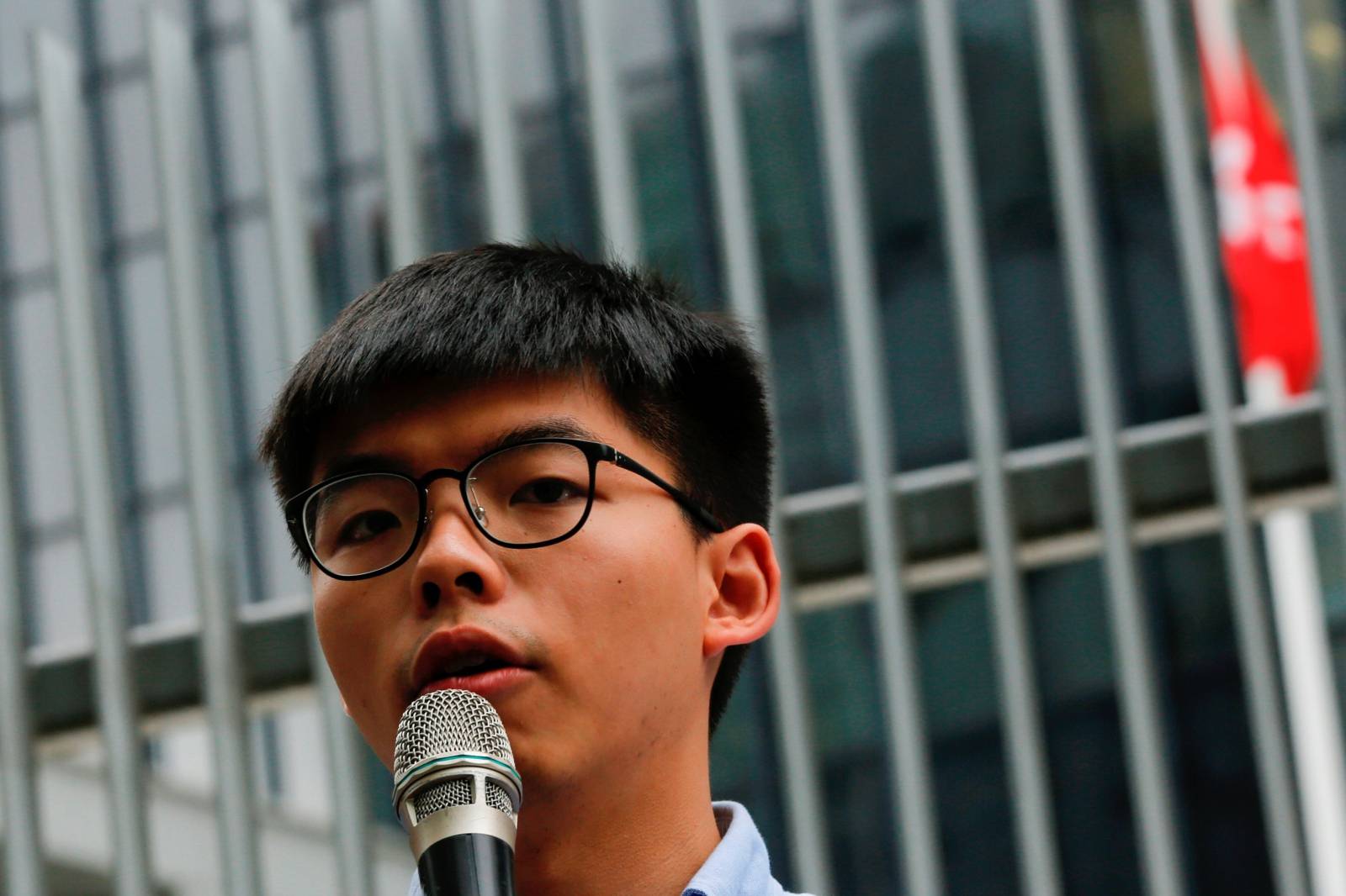 Pro-democracy activist Joshua Wong speaks to journalists after being disqualified from running in the local district's council elections in November, in Hong Kong