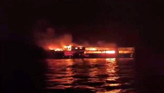 MV June Aster burns as flames and smoke rise after a fire broke out on the ferry, off the coast of Palawan