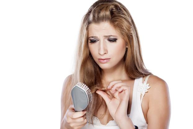 Headshot of a nervous girl with a hairbrush