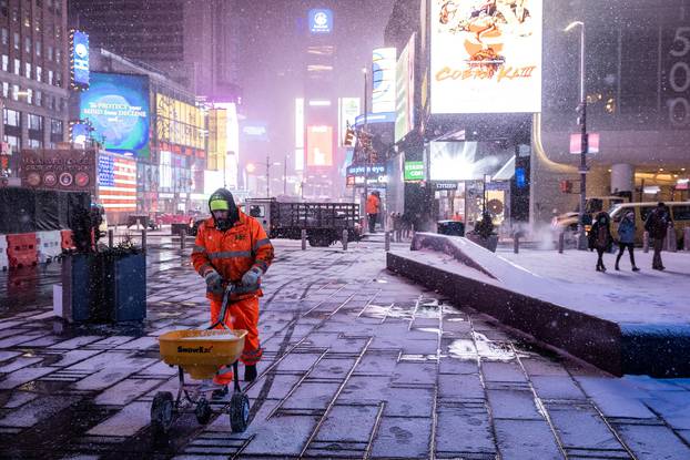 Snow begins to fall in Times Square during a snow storm, during the coronavirus disease (COVID-19) pandemic in the Manhattan borough of New York City