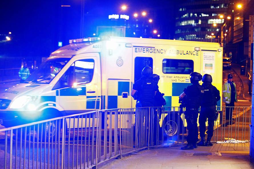 Armed police officers stand near the Manchester Arena, where U.S. singer Ariana Grande had been performing, in Manchester, in northern England, Britain