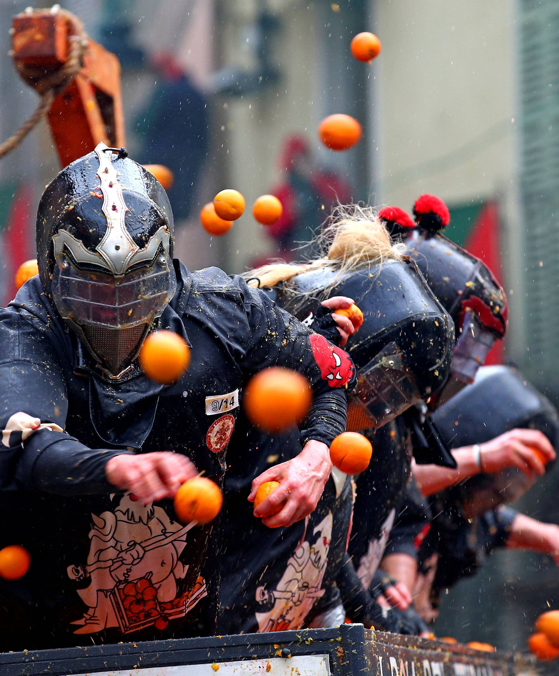 Members of rival teams fight with oranges during an annual carnival battle in the northern Italian town of Ivrea