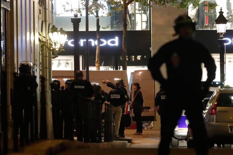 Police secure a side street as other conduct an investigation on the Champs Elysees Avenue after one policeman was killed and another wounded in a shooting incident in Paris