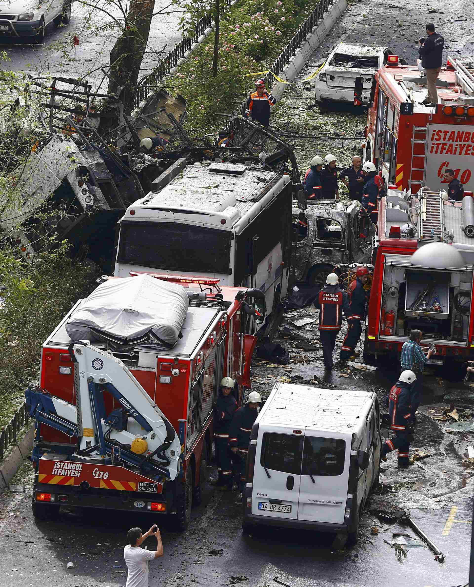 Fire engines stand beside a Turkish police bus which was targeted in a bomb attack in a central Istanbul district