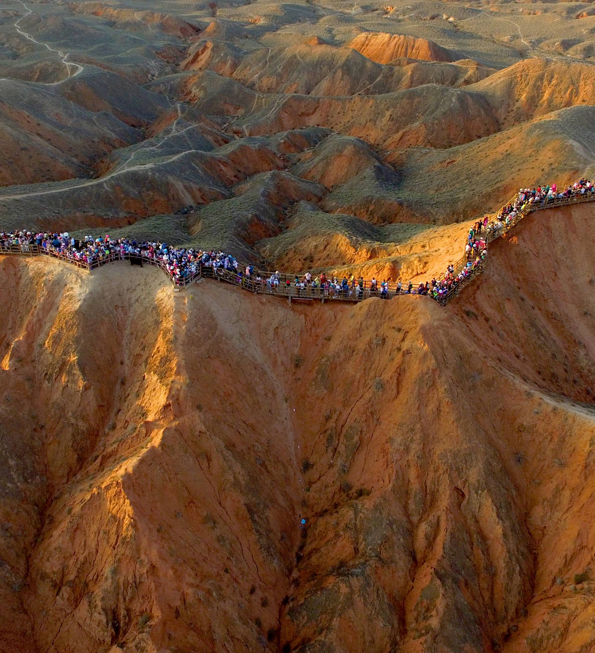 An aerial view shows people visiting an area of Danxia landform in Zhangye