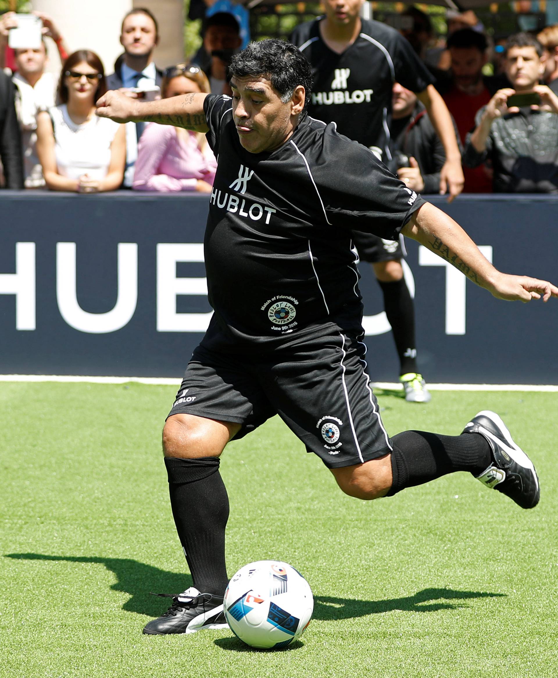 Football legend Diego Maradona plays soccer during an advertising event on the eve of the opening of the UEFA 2016 European Championship in Paris