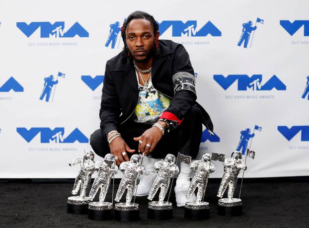 FILE PHOTO: Musician Kendrick Lamar poses for pictures with his awards at the 2017 MTV Video Music Awards in Inglewood