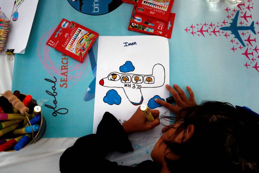 MH370 flight attendant, Mohamad Hazrin Hasnan's daughter, colours plane during its fourth annual remembrance event in Kuala Lumpur