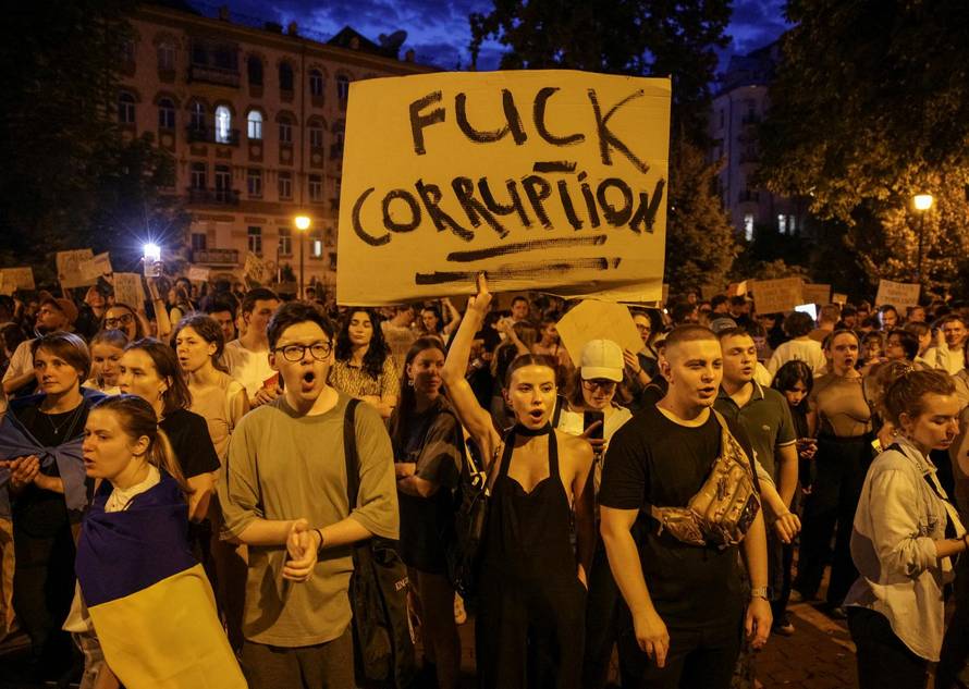 Ukrainians protest against a newly passed law, which curbs independence of anti-corruption institutions, near the presidential office in Kyiv