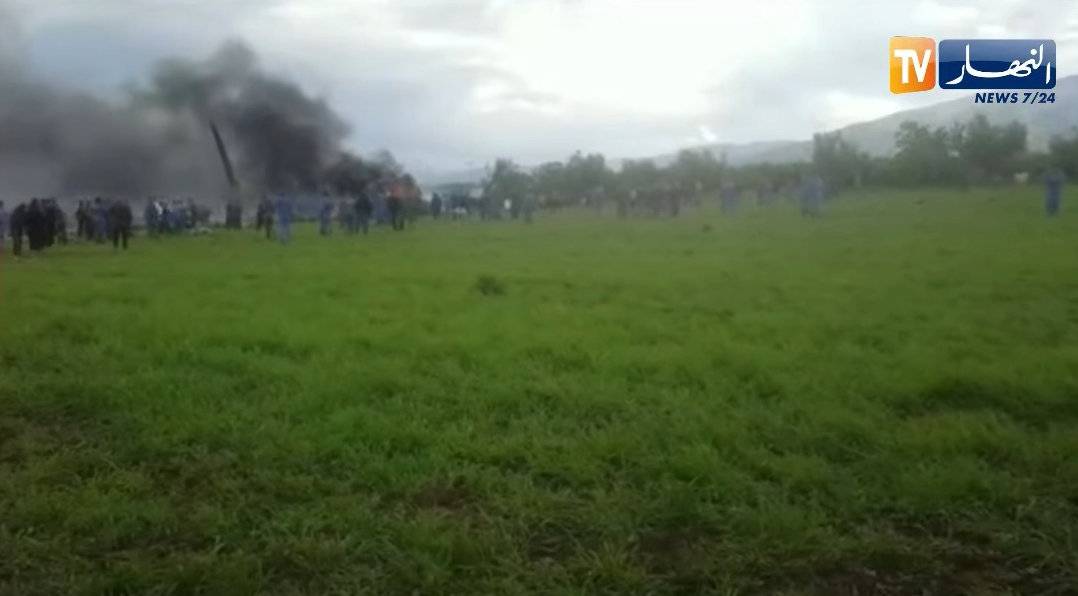 Smoke rises at the scene where a plane crashed into a field outside Algiers